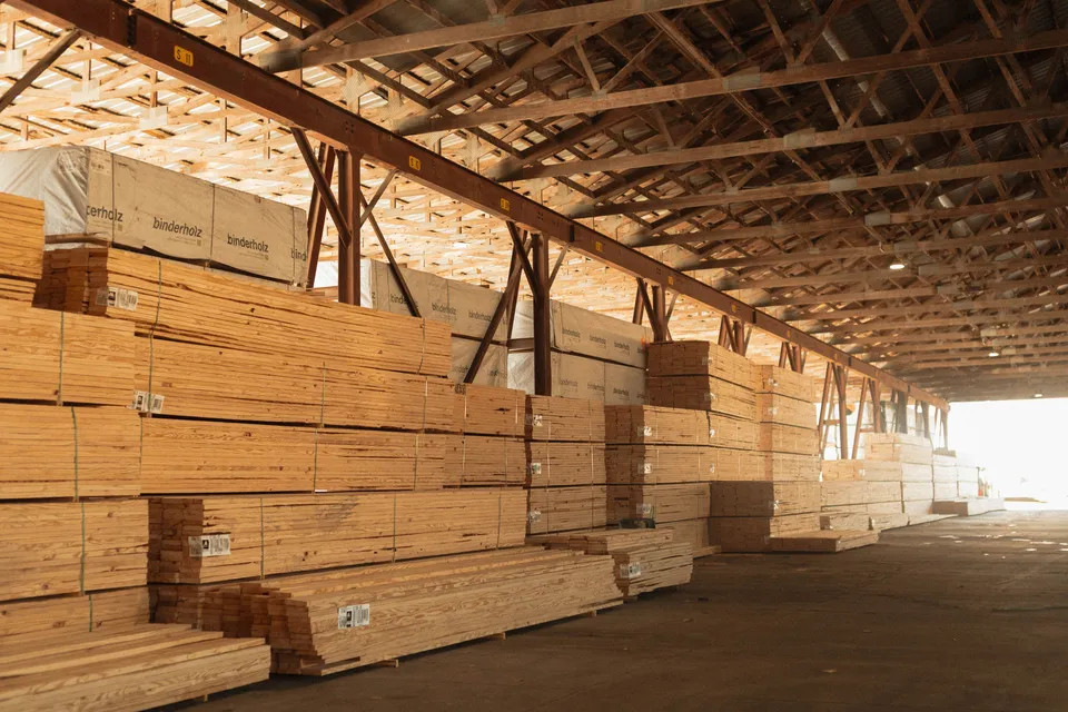 Lumber stacked under shade